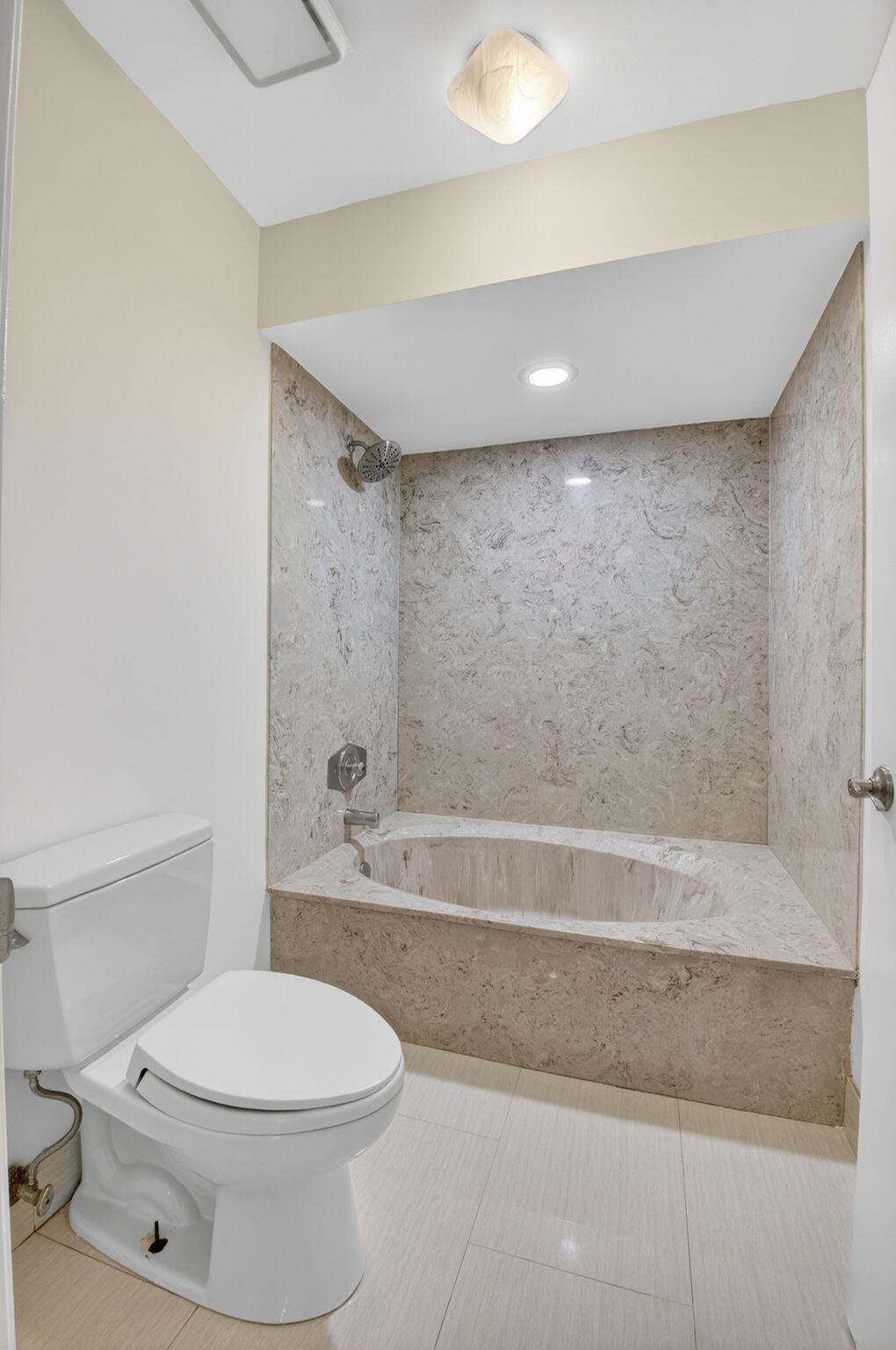 5845 Fox Hollow Drive, Unit A Boca Raton, FL 33486 - Photo 15 of 50 a bathroom with a toilet a sink and a bathtub