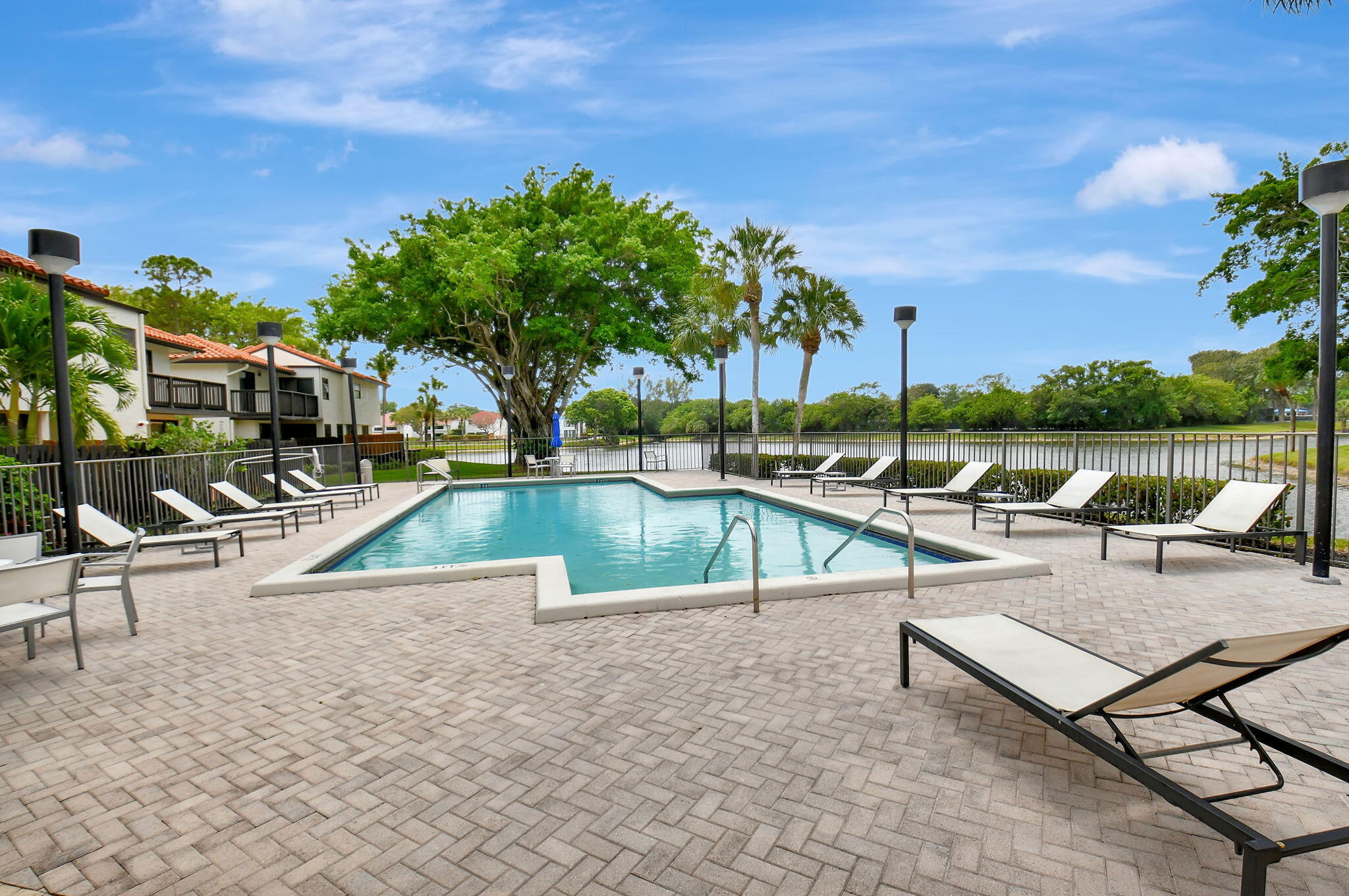 5845 Fox Hollow Drive, Unit A Boca Raton, FL 33486 - Photo 29 of 50 an outdoor space with swimming pool and furniture