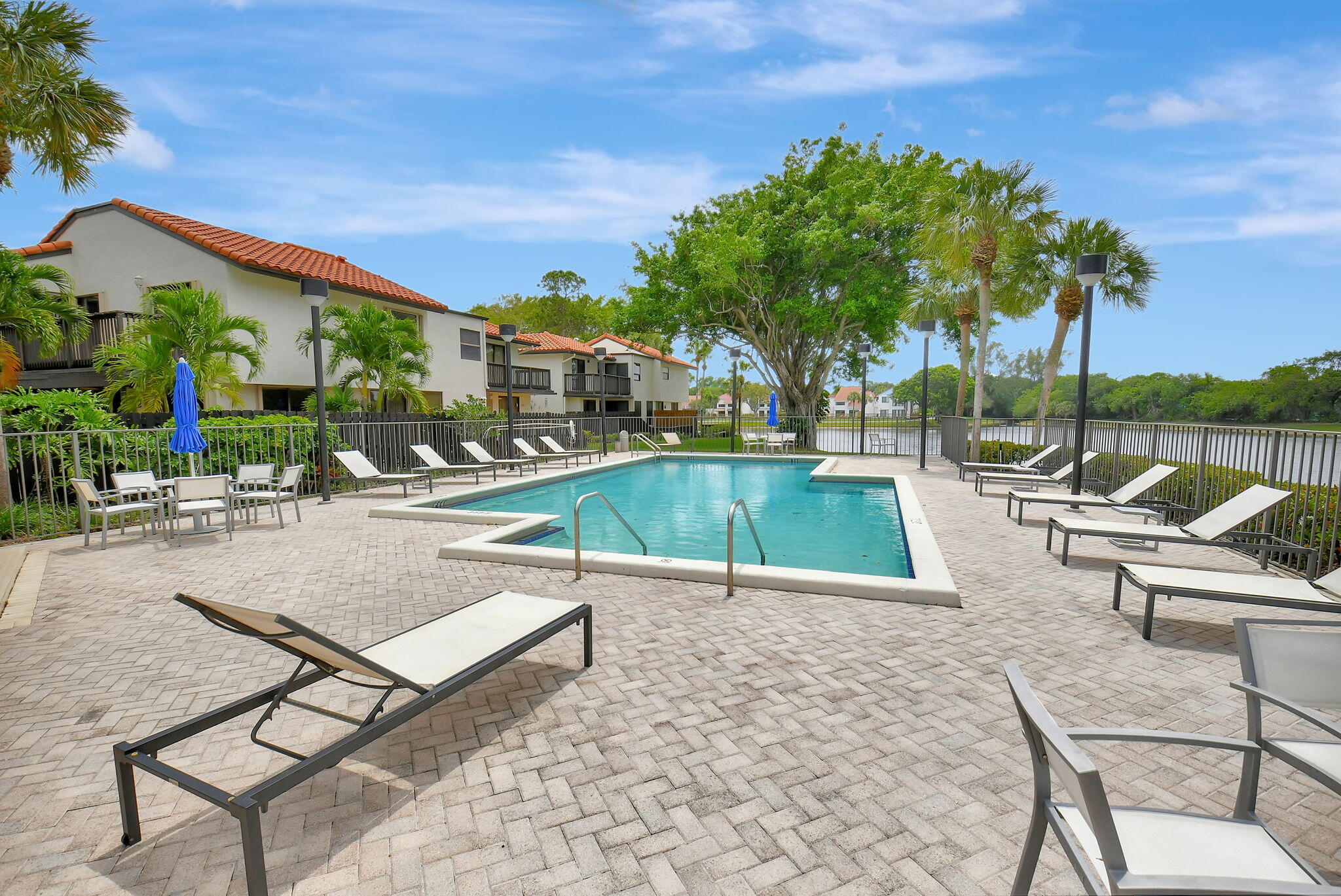 5845 Fox Hollow Drive, Unit A Boca Raton, FL 33486 - Photo 30 of 50 a view of a patio with swimming pool