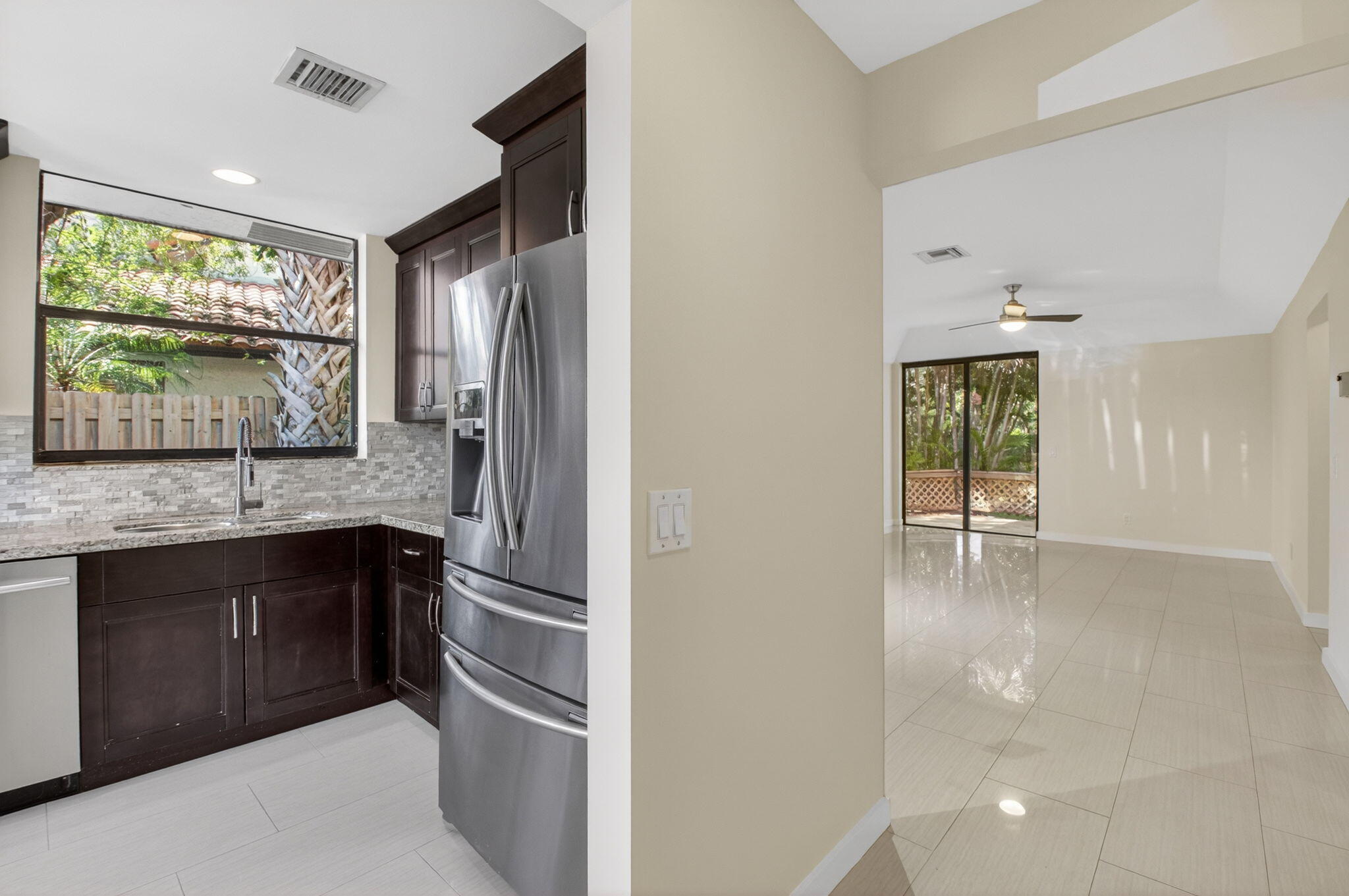 5845 Fox Hollow Drive, Unit A Boca Raton, FL 33486 - Photo 3 of 50 a kitchen with a refrigerator and large window
