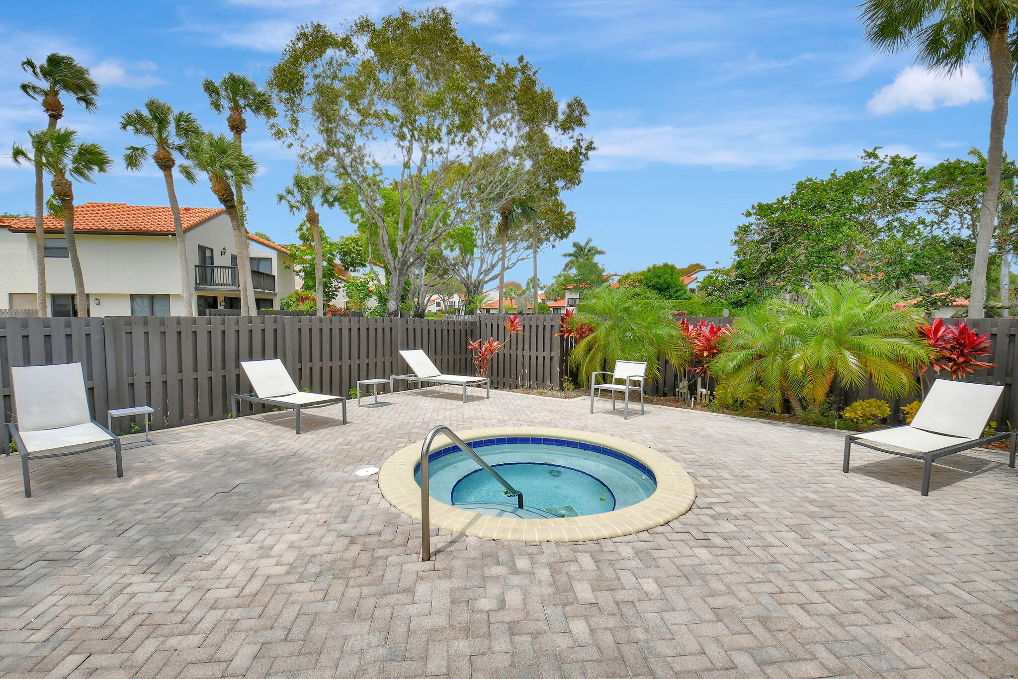 5845 Fox Hollow Drive, Unit A Boca Raton, FL 33486 - Photo 31 of 50 a view of a swimming pool with a patio