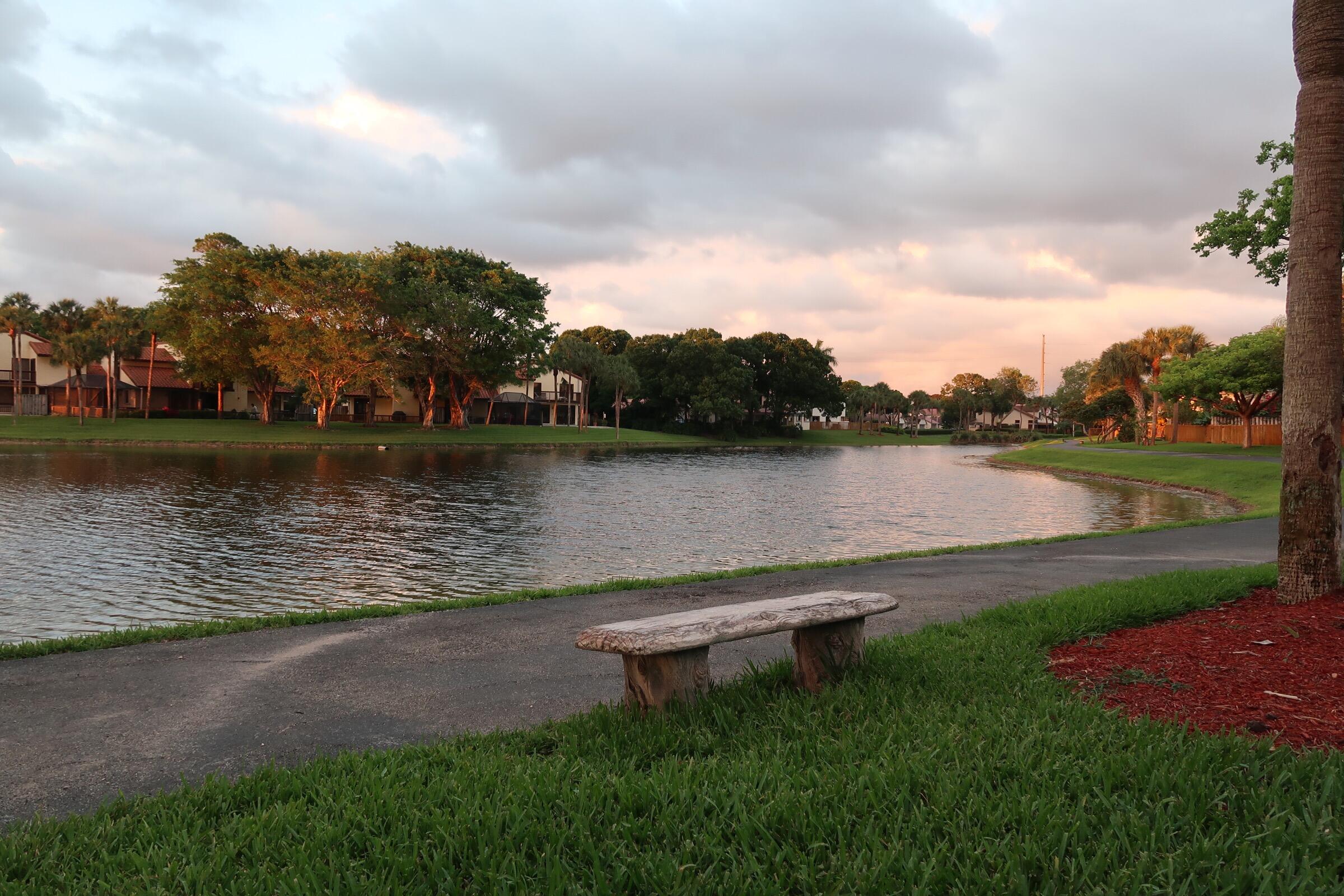 5845 Fox Hollow Drive, Unit A Boca Raton, FL 33486 - Photo 40 of 50 a view of a lake with houses in the back