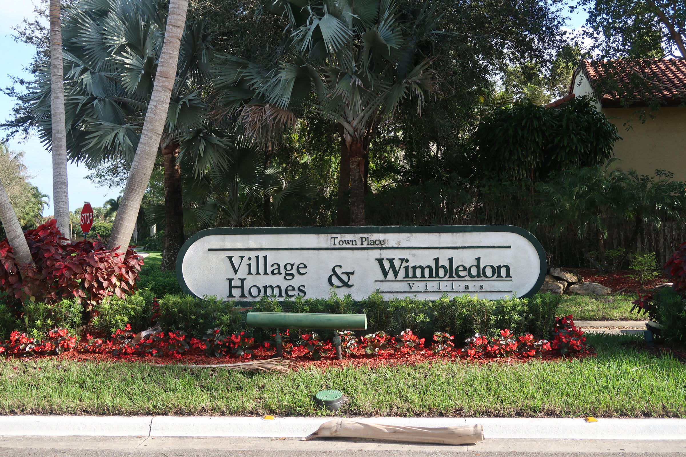 5845 Fox Hollow Drive, Unit A Boca Raton, FL 33486 - Photo 49 of 50 a sign that is sitting in front of flowers