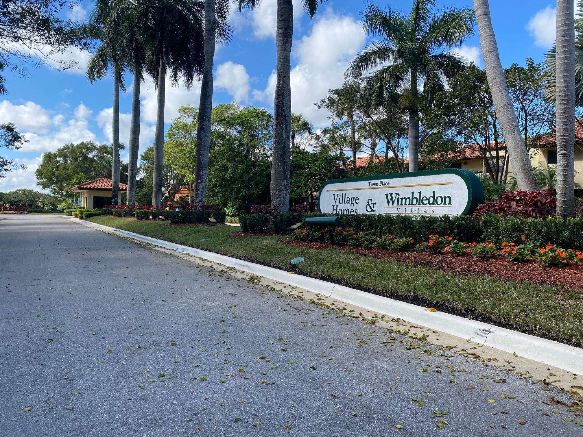 5845 Fox Hollow Drive, Unit A Boca Raton, FL 33486 - Photo 50 of 50 a view of a park along palm trees and sign board