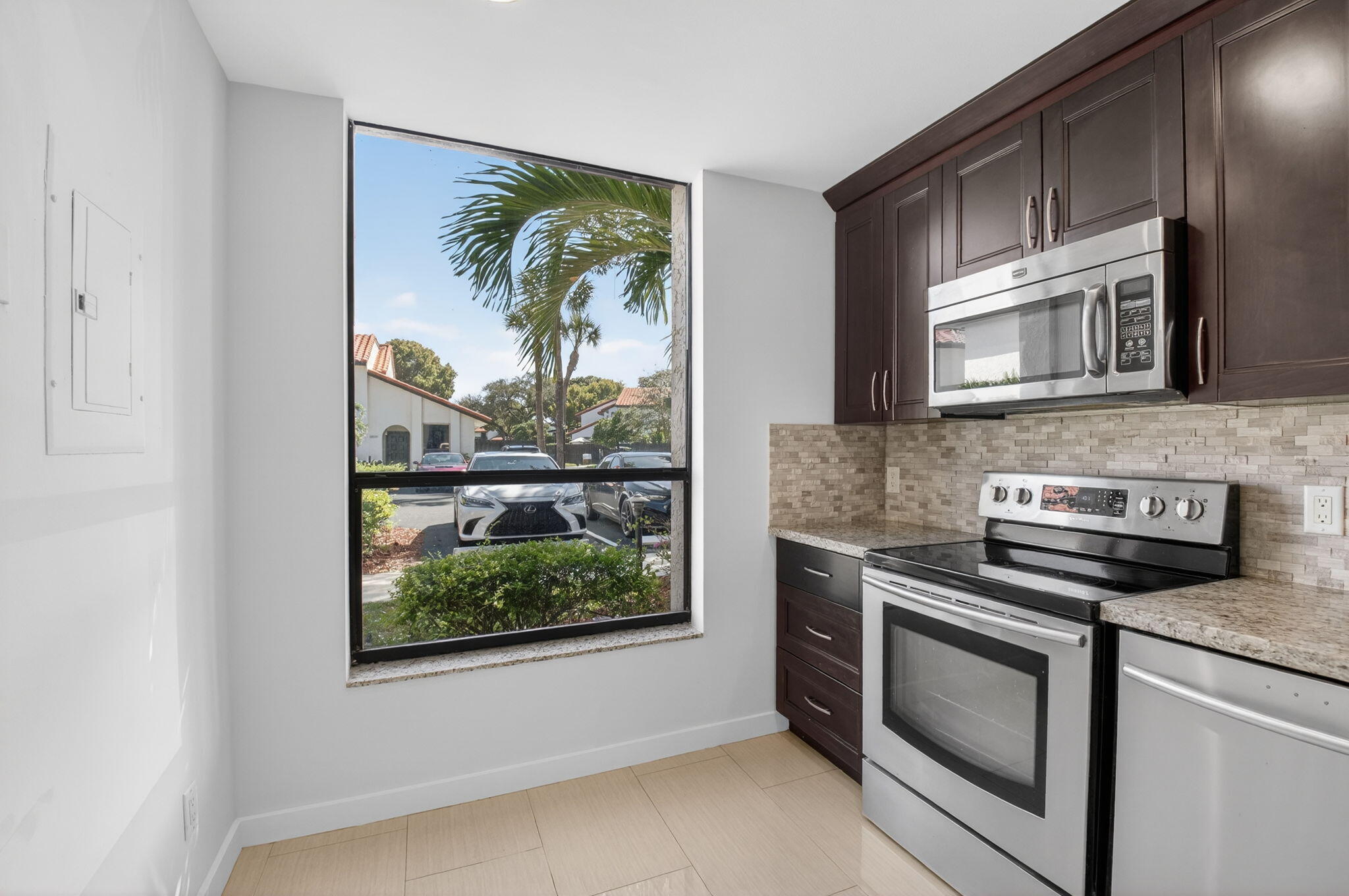 5845 Fox Hollow Drive, Unit A Boca Raton, FL 33486 - Photo 6 of 50 a kitchen with a stove microwave and sink
