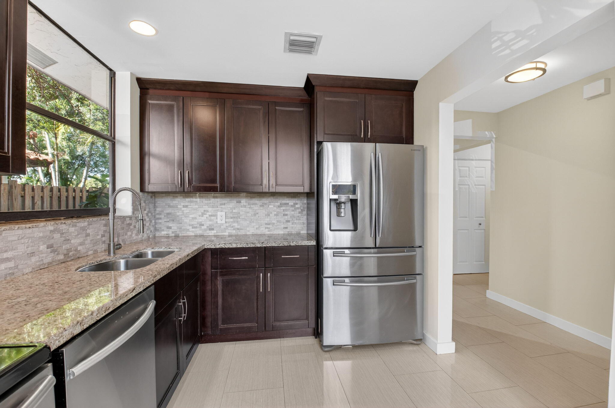 5845 Fox Hollow Drive, Unit A Boca Raton, FL 33486 - Photo 7 of 50 a kitchen with stainless steel appliances granite countertop a refrigerator and a sink