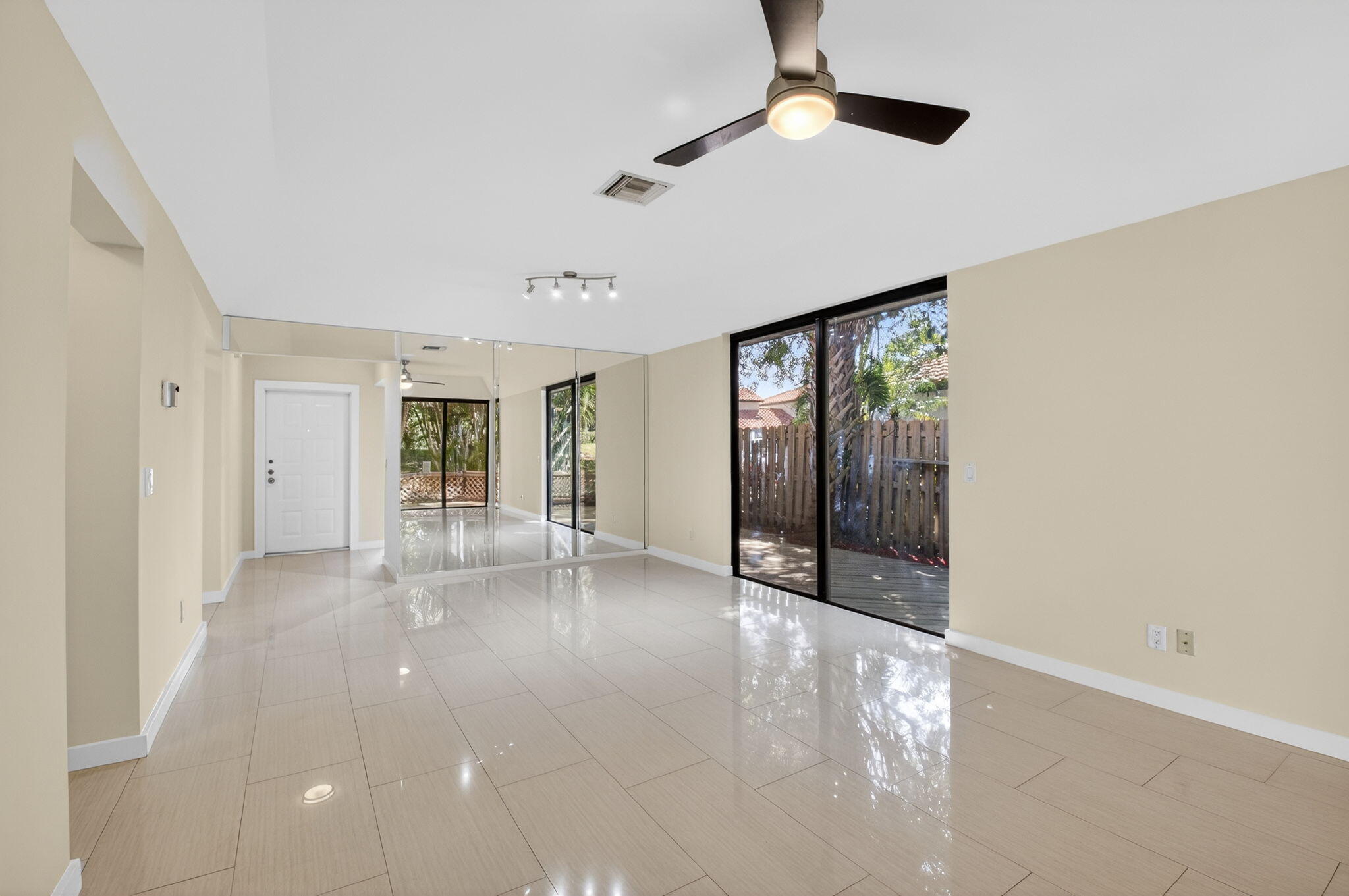 5845 Fox Hollow Drive, Unit A Boca Raton, FL 33486 - Photo 10 of 50 a view of a livingroom with wooden floor and chandelier fan