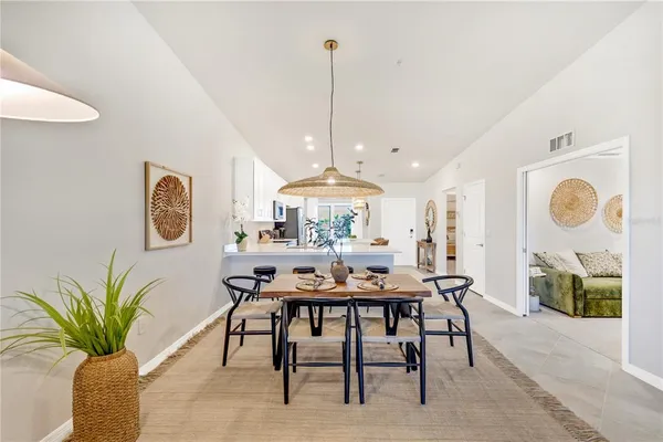 a view of a dining room with furniture and chandelier