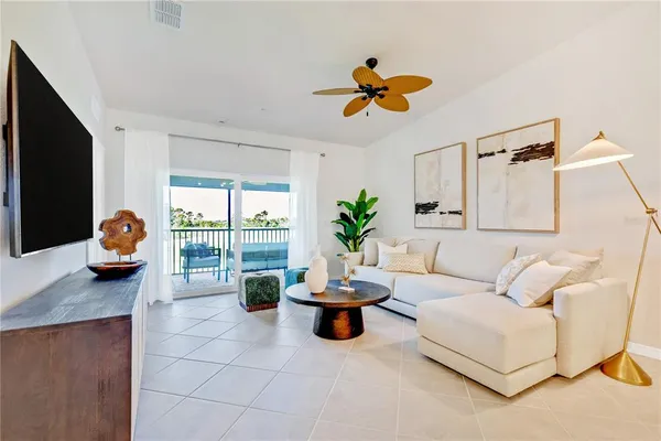 a living room with furniture and a potted plant
