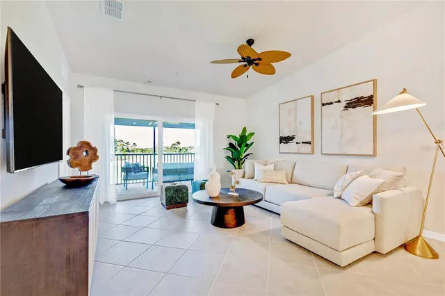 a living room with furniture and a potted plant