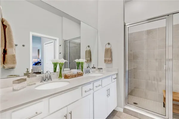 a bathroom with a granite countertop toilet sink and mirror