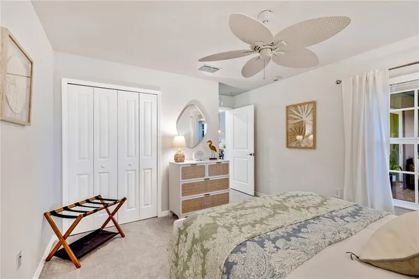 a front view of a house with glass windows and furniture
