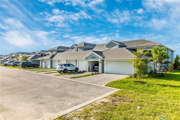 a view of a house with backyard porch and sitting area
