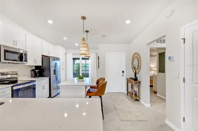 a kitchen with a sink dishwasher and a stove with wooden floor