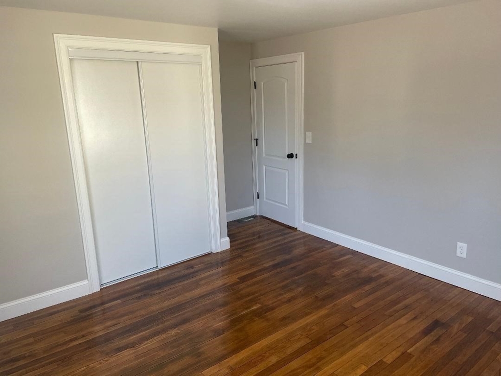 210 Navajo Road Springfield, MA 01109 - Photo 24 of 38 a view of an empty room with wooden floor