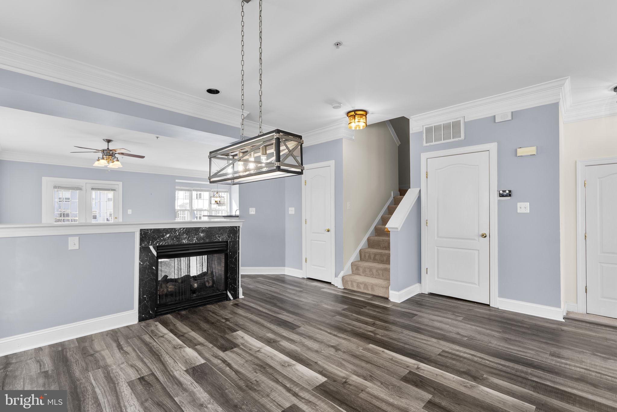 932 Orchard Ridge Drive, Unit 200 Gaithersburg, MD 20878 - Photo 12 of 51 a view of a livingroom with wooden floor and a ceiling fan