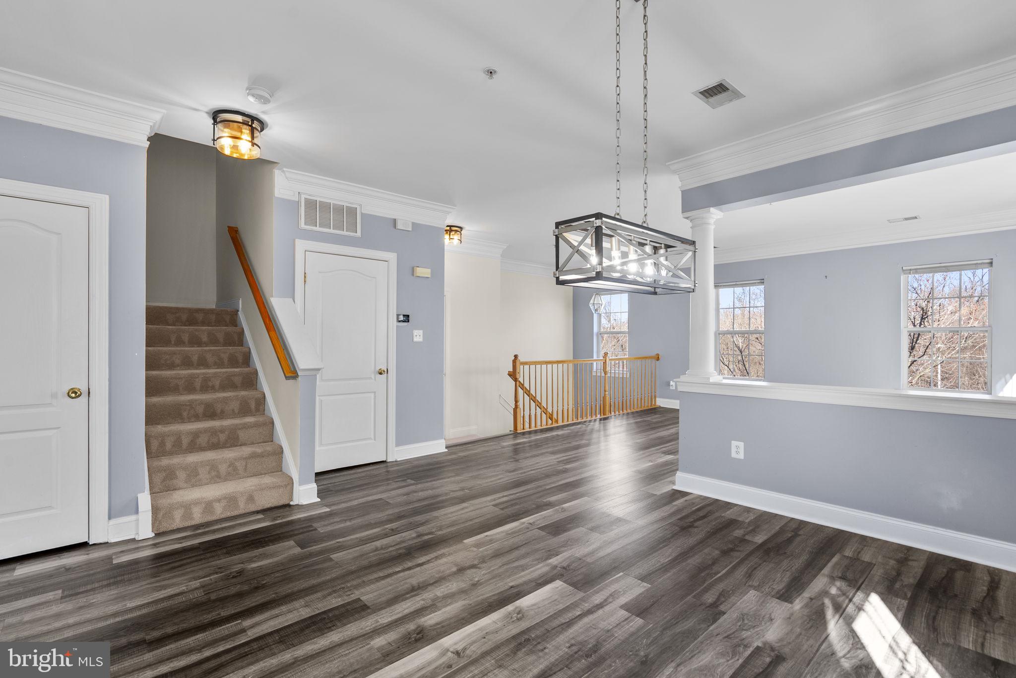 932 Orchard Ridge Drive, Unit 200 Gaithersburg, MD 20878 - Photo 13 of 51 a view of a livingroom with wooden floor and staircase