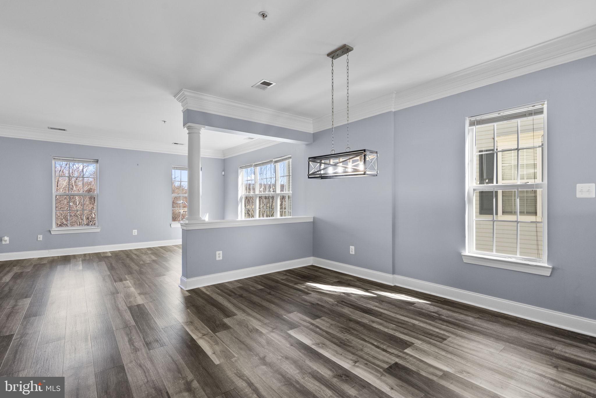 932 Orchard Ridge Drive, Unit 200 Gaithersburg, MD 20878 - Photo 15 of 51 a view of an empty room with wooden floor and a window