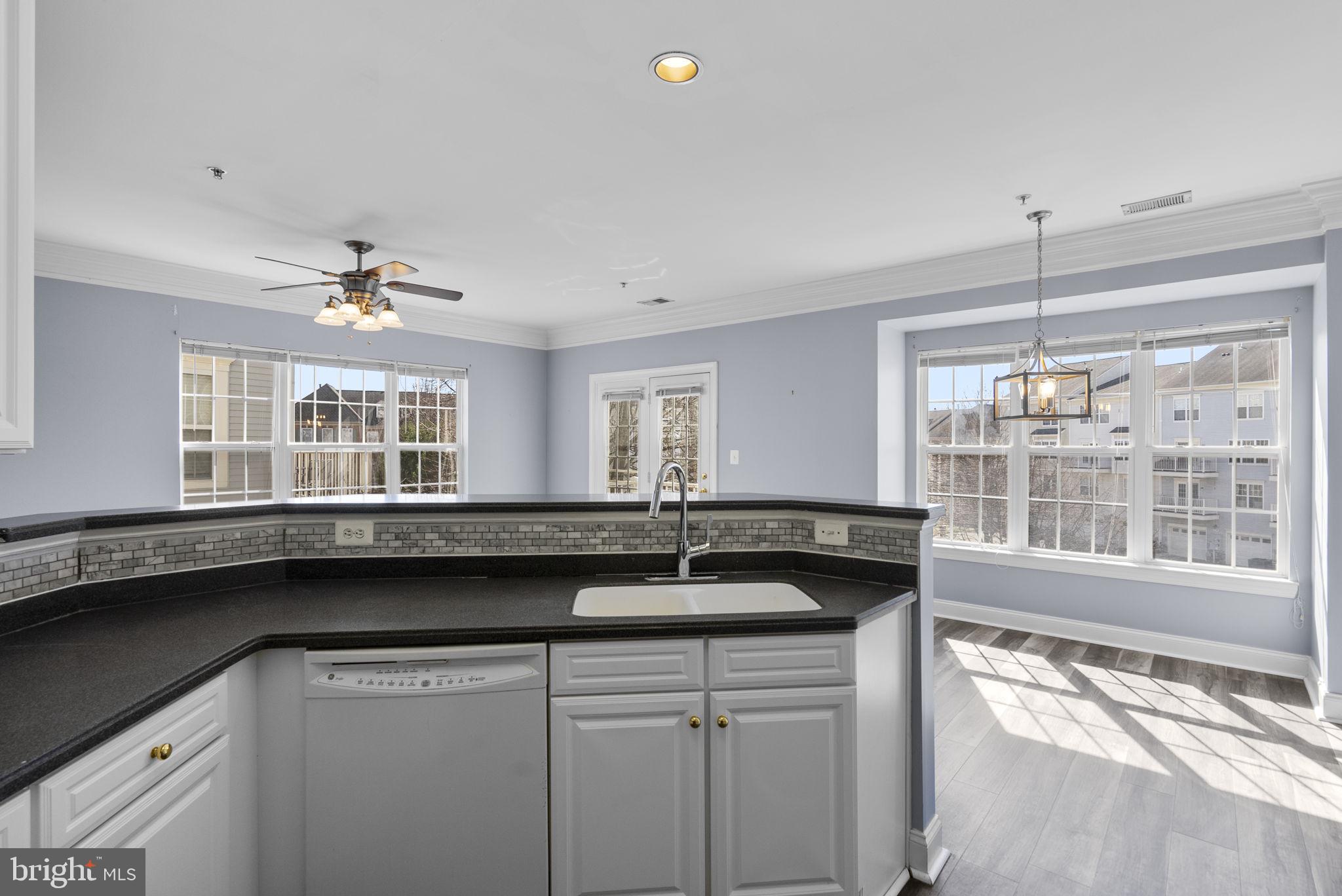 932 Orchard Ridge Drive, Unit 200 Gaithersburg, MD 20878 - Photo 27 of 51 a kitchen with a sink and large windows