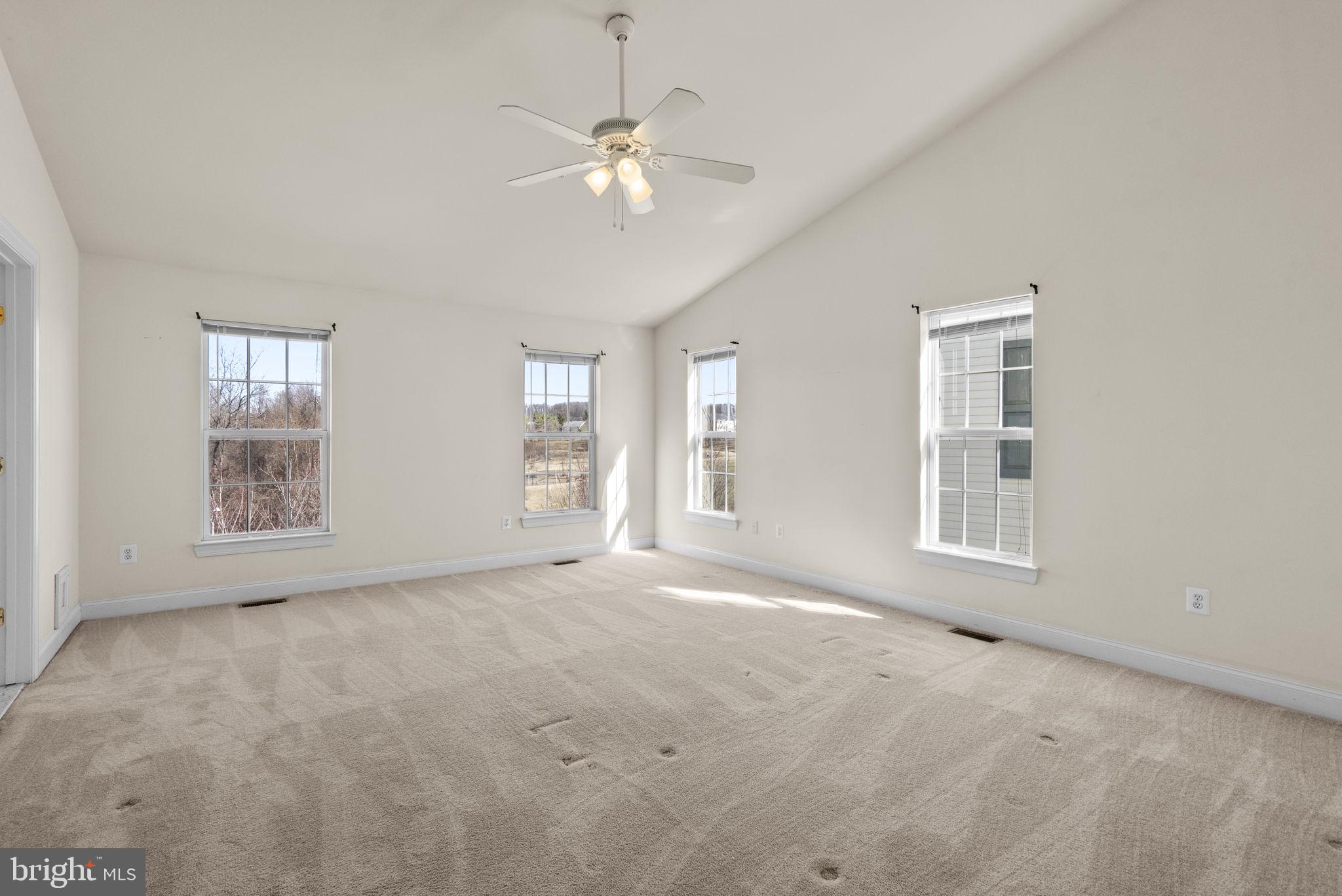 932 Orchard Ridge Drive, Unit 200 Gaithersburg, MD 20878 - Photo 31 of 51 an empty room with chandelier fan and windows