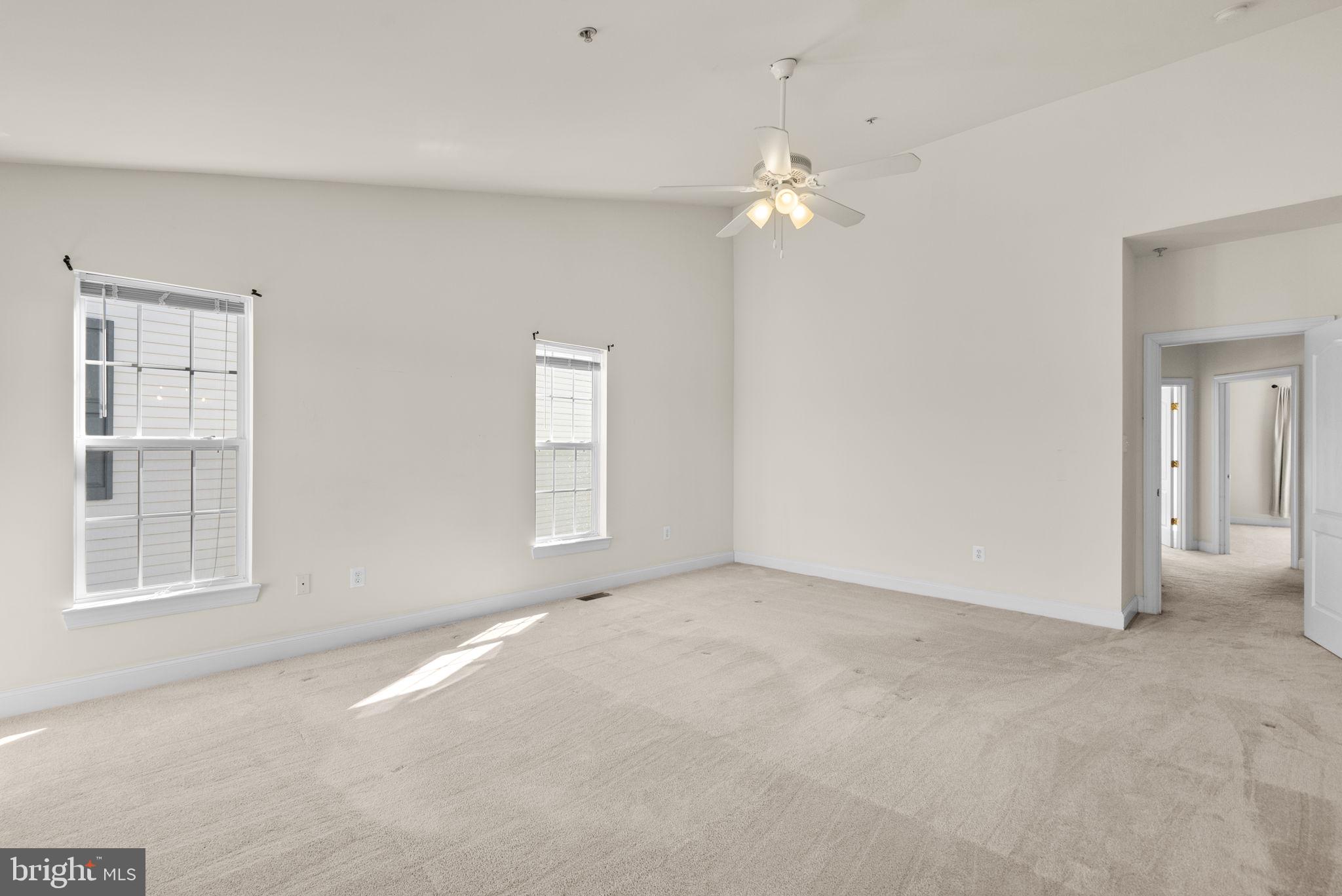 932 Orchard Ridge Drive, Unit 200 Gaithersburg, MD 20878 - Photo 33 of 51 en empty room with windows and chandelier fan