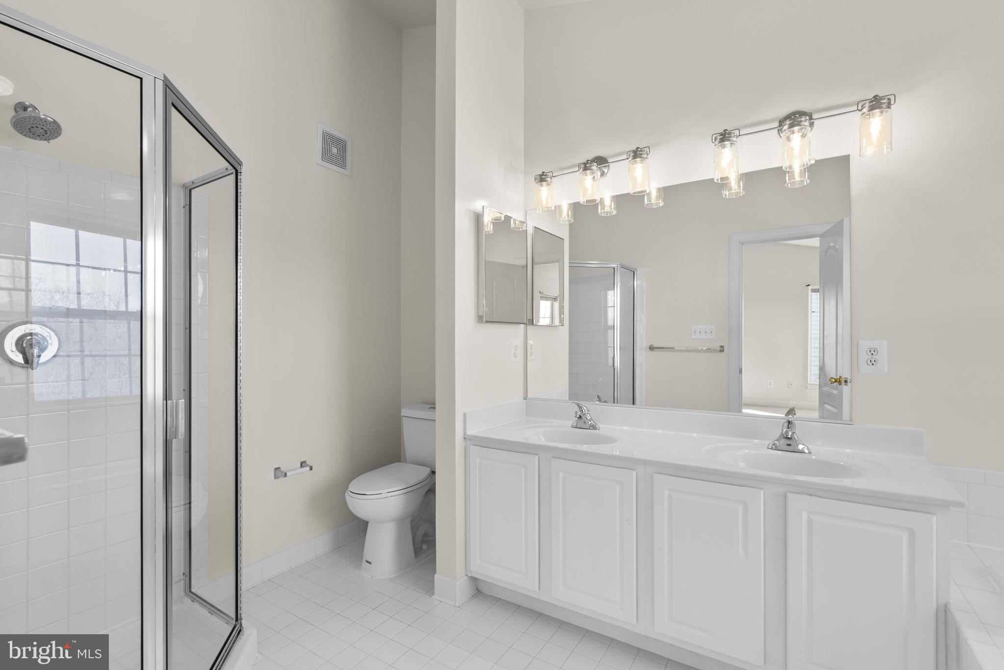 932 Orchard Ridge Drive, Unit 200 Gaithersburg, MD 20878 - Photo 34 of 51 a bathroom with a double vanity sink mirror and toilet