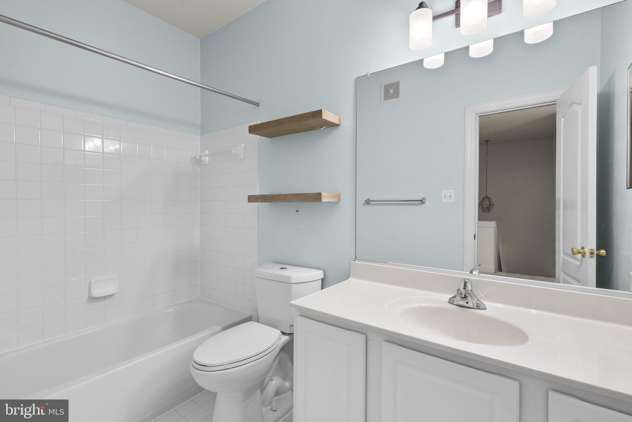932 Orchard Ridge Drive, Unit 200 Gaithersburg, MD 20878 - Photo 38 of 51 a bathroom with a sink a toilet and a mirror