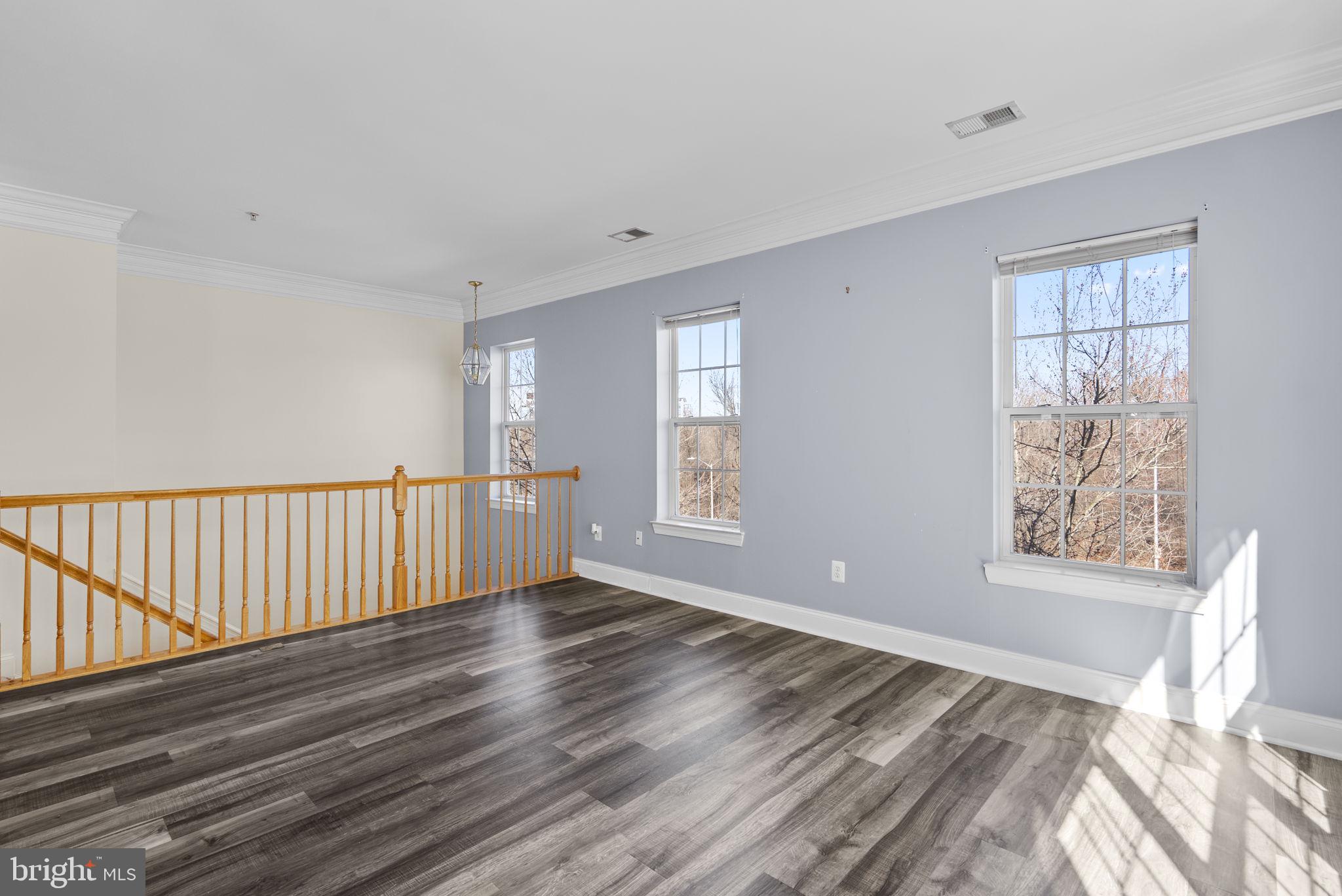 932 Orchard Ridge Drive, Unit 200 Gaithersburg, MD 20878 - Photo 7 of 51 a view of an empty room with wooden floor and a window