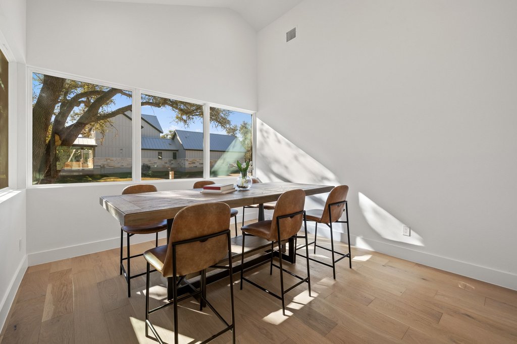 47 War Bonnet Wimberley, TX 78676 - Photo 19 of 40 a view of a dining room with furniture and wooden floor