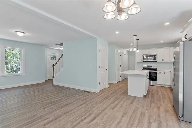 a view of kitchen with cabinets and wooden floor