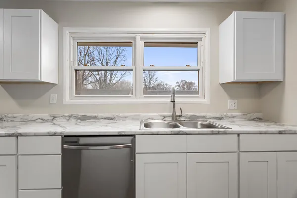 a kitchen with a sink and cabinets