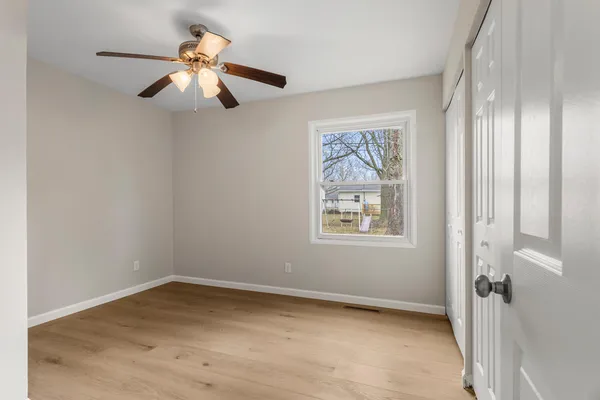 wooden floor in an empty room with a window