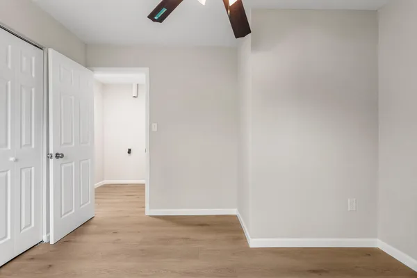 a view of a room with a ceiling fan
