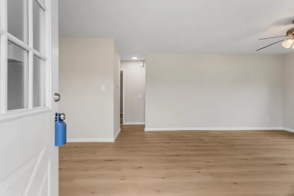 a view of an empty room and wooden floor