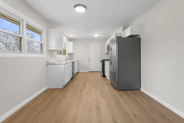 a kitchen with a refrigerator and window