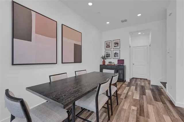 a kitchen with stainless steel appliances kitchen island granite countertop a sink a stove and chairs