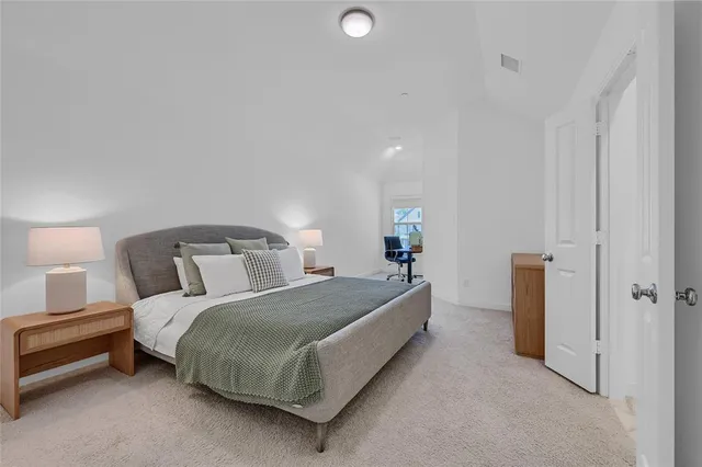 a bedroom with a bed and a lamp