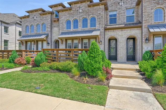 a view of a brick building next to a yard