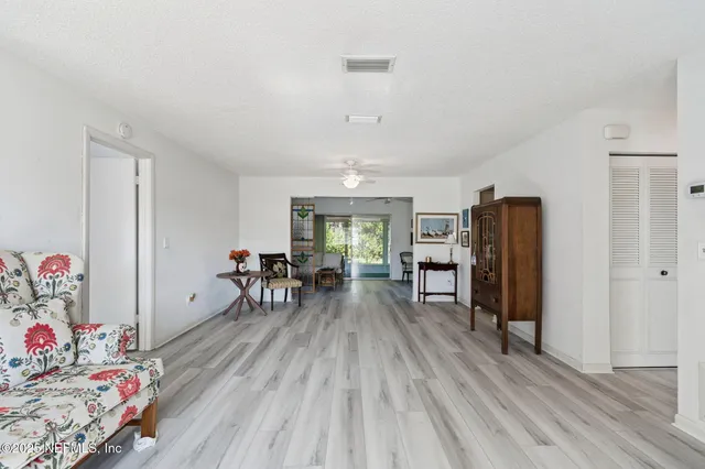 a bathroom with a granite countertop sink a mirror and a shower
