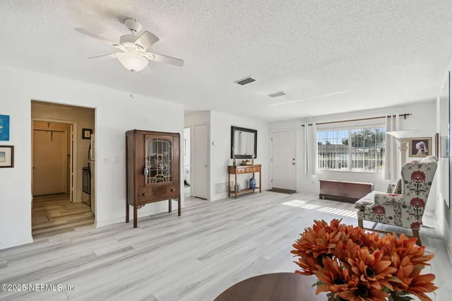 a kitchen with a refrigerator and a stove top oven
