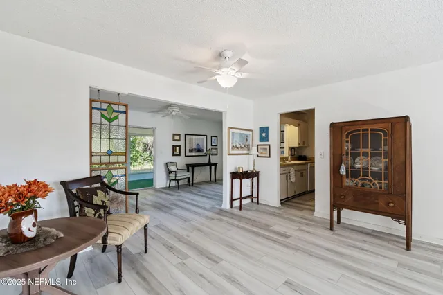 a kitchen with stainless steel appliances granite countertop white cabinets and a stove a refrigerator with white countertops