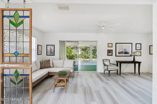 a view of a livingroom with furniture and hardwood floor
