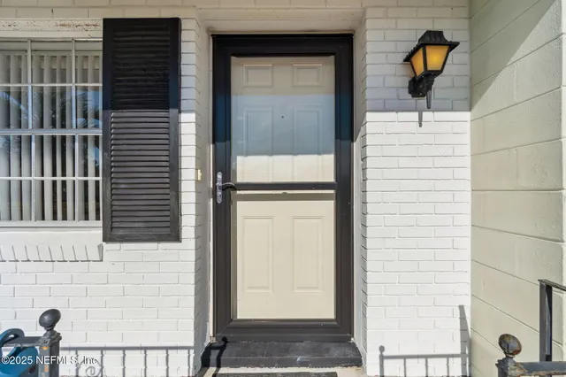 a view of a porch with a floor to ceiling window and stairs