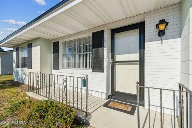 a front view of house with yard and car parked