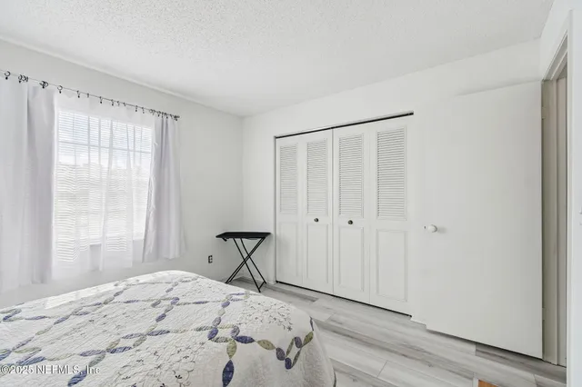 a front view of a house with a yard tree and outdoor seating