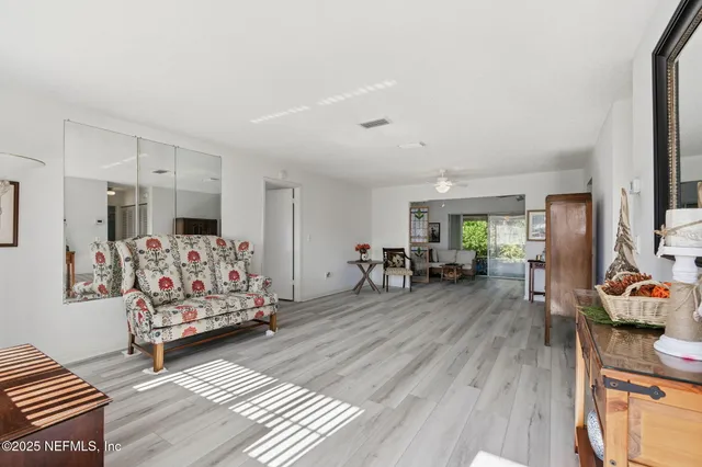 a living room with furniture fireplace and wooden floor