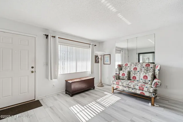 a bedroom with furniture and a window