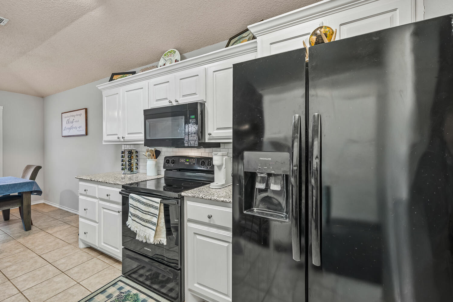 10607 Dover Avenue Lubbock, TX 79424 - Photo 14 of 34 a kitchen with stainless steel appliances a refrigerator stove and microwave