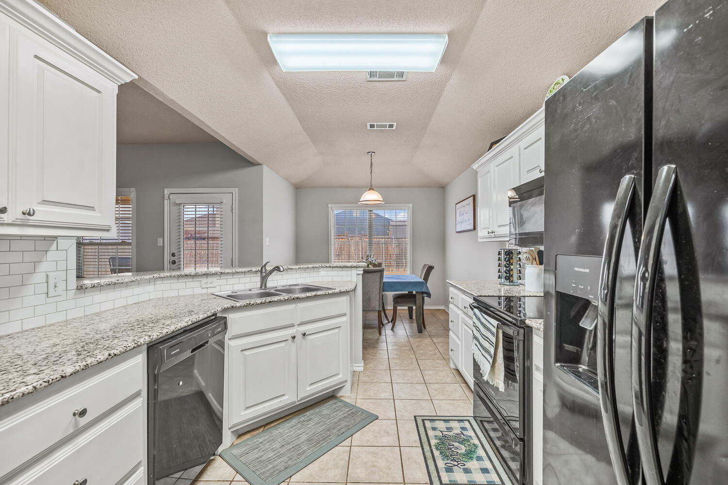 10607 Dover Avenue Lubbock, TX 79424 - Photo 16 of 34 a kitchen with stainless steel appliances granite countertop a sink stove and refrigerator