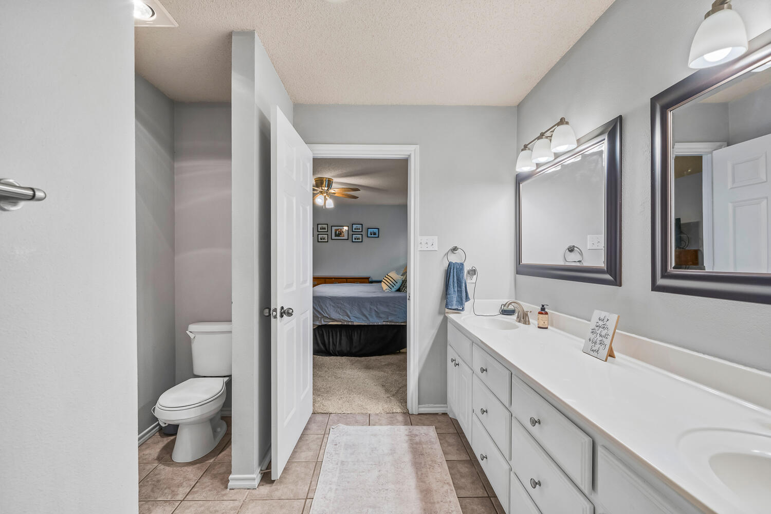 10607 Dover Avenue Lubbock, TX 79424 - Photo 21 of 34 a spacious bathroom with a double vanity sink toilet and shower